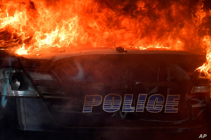 An Atlanta Police Department vehicle burns during a demonstration against police violence, Friday, May 29, 2020 in Atlanta. The…