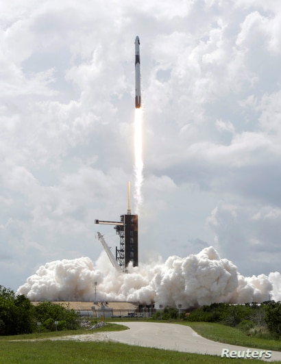 A SpaceX Falcon 9 rocket and Crew Dragon spacecraft carrying NASA astronauts Douglas Hurley and Robert Behnken lifts off during…