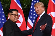 (FILES) In this file photo taken on June 11, 2018 US President Donald Trump (R) gestures as he meets with North Korea's leader…