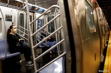 Morning commuters ride a Metropolitan Transportation Authority (MTA) subway, as phase one of reopening after lockdown begins,…