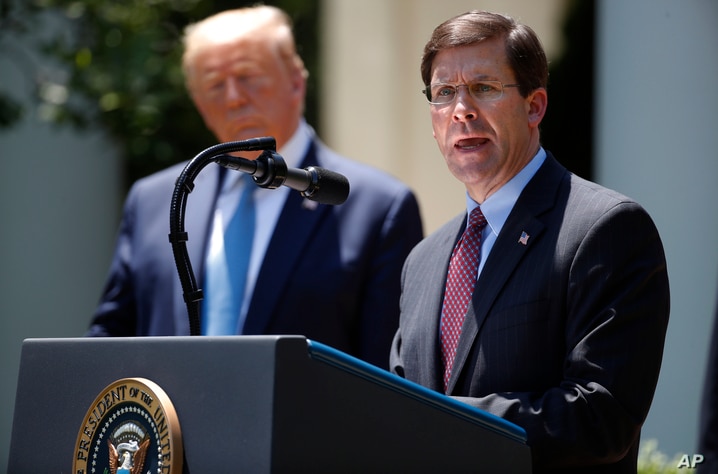 Defense Secretary Mark Esper speaks as President Donald Trump listens during a press briefing about the coronavirus in the Rose…