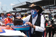 NASCAR driver Bubba Wallace is consoled by team owner Richard Petty, right, prior to the start of the NASCAR Cup Series at the…